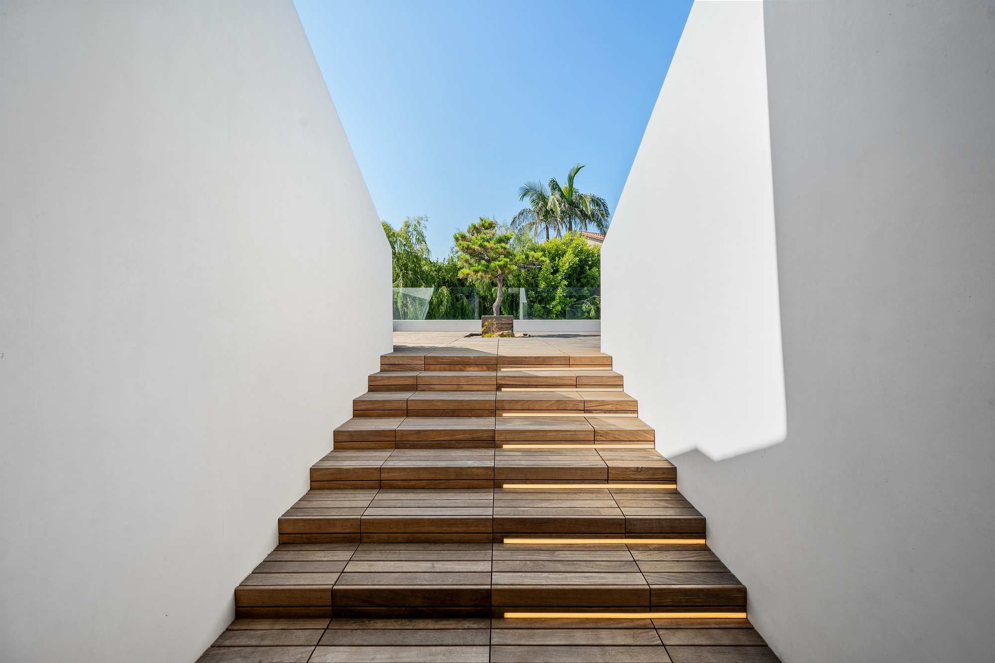 an architectural structure made from wood and concrete, has stairs made out of wood and