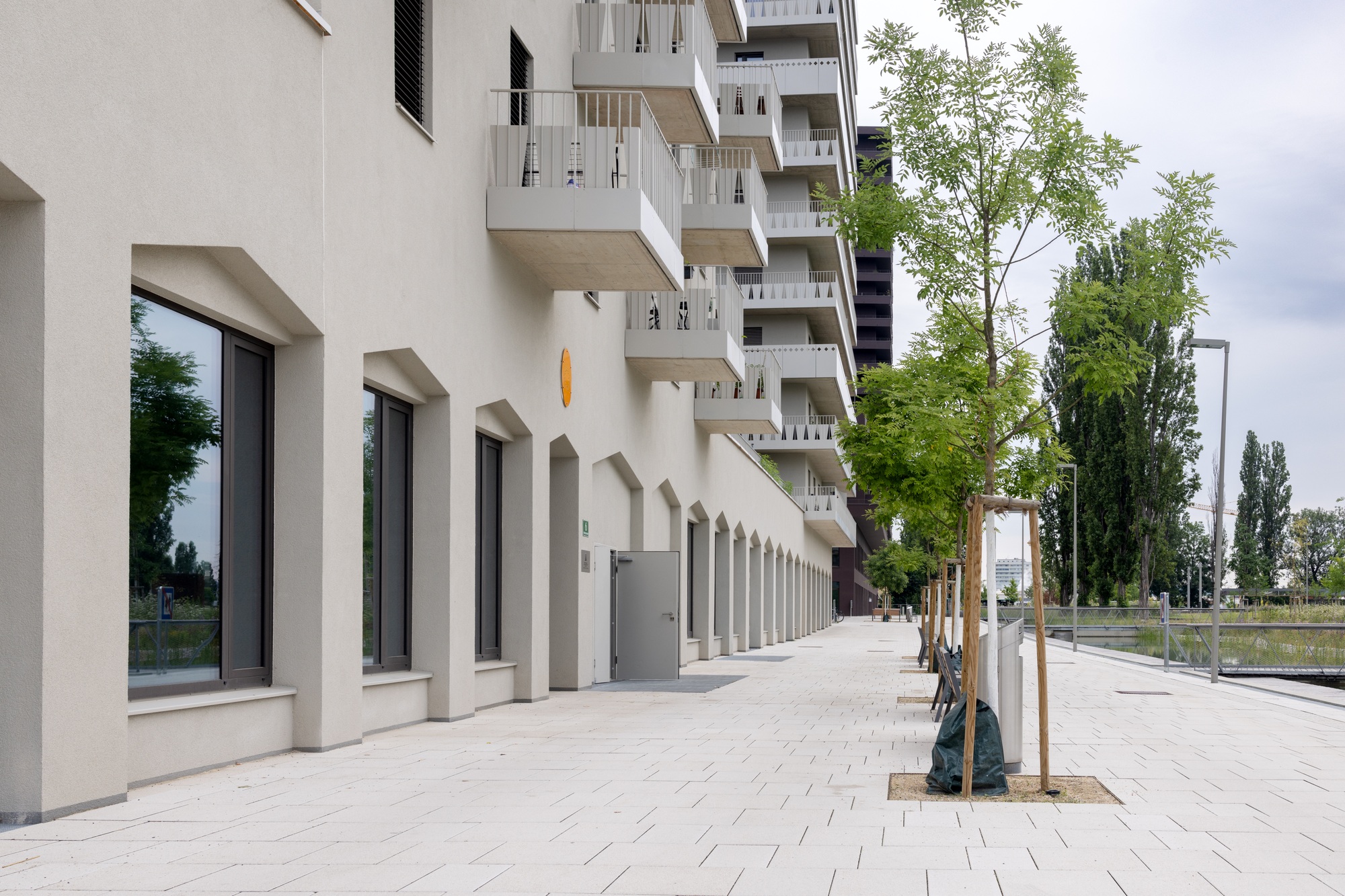 Commercial ground floor of building and pedestrian area, residential buildings, modern architecture