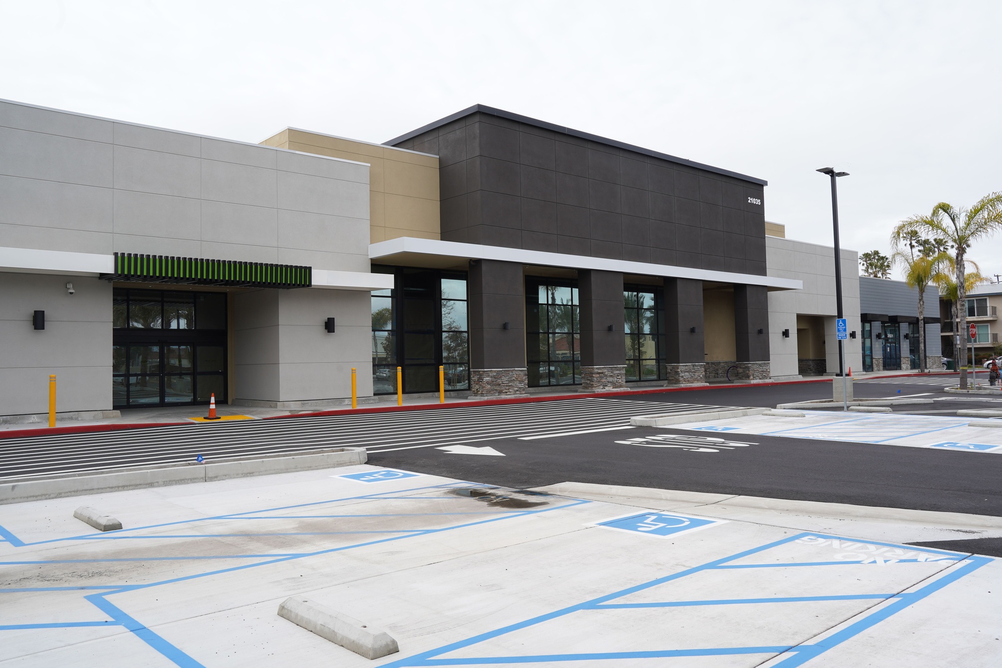 Empty parking lot in the daylight with a modern building on the background