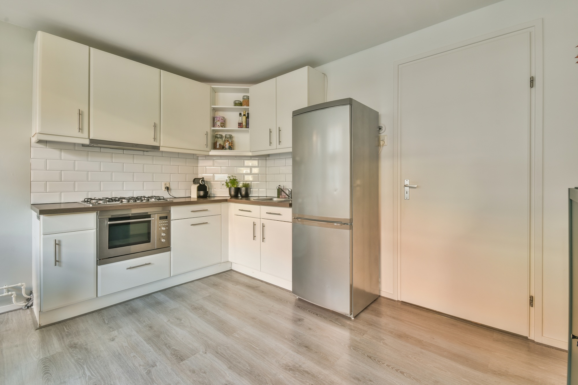 Spacious attic room with sofa and kitchen